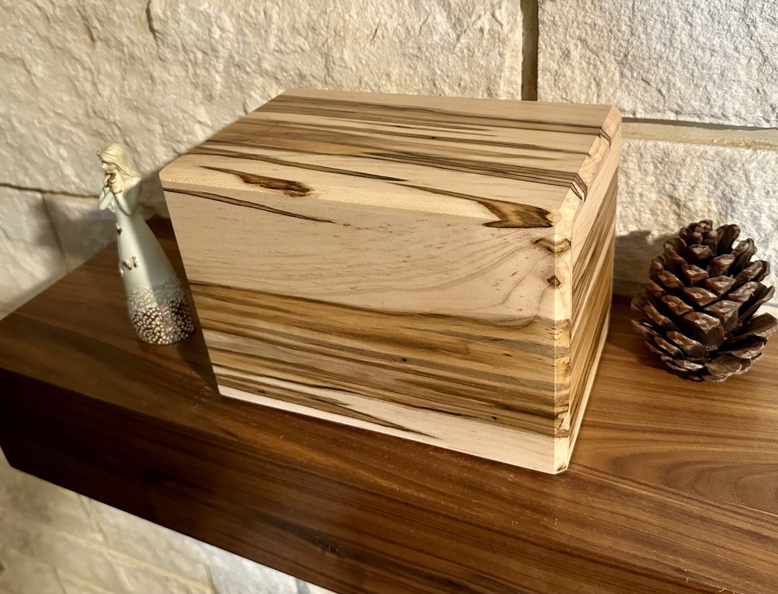 A natural wood pet urn handcrafted by Will